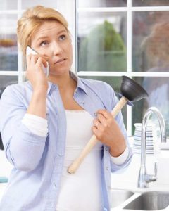 lady with plunger for kitchen sink