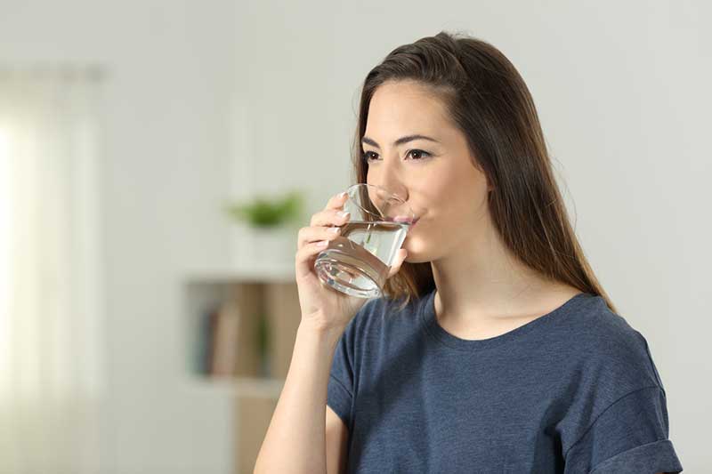 woman drinking glass of water